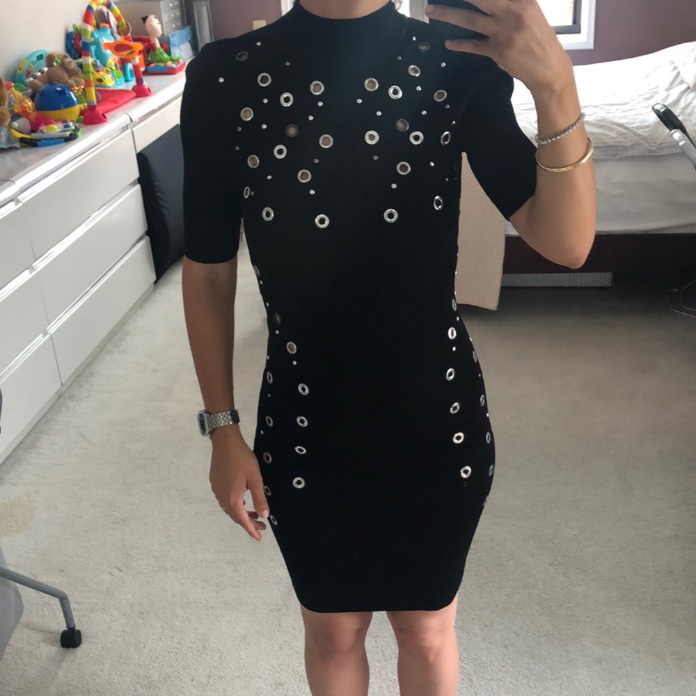 Black cocktail dress. 3/4 length sleeve. Dress goes above knee—Model is 5’3